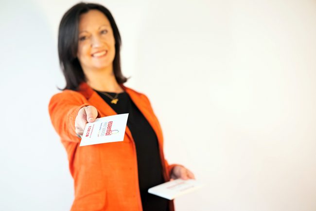 Printed-Flyers-Derby-Essential-Print-Services Yvonne is shown holding out her arm with a printing flyer