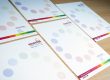 Lots of Essential Print Letterheads on a wooden desk
