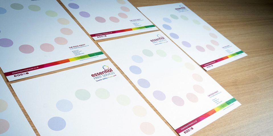 Lots of Essential Print Letterheads on a wooden desk