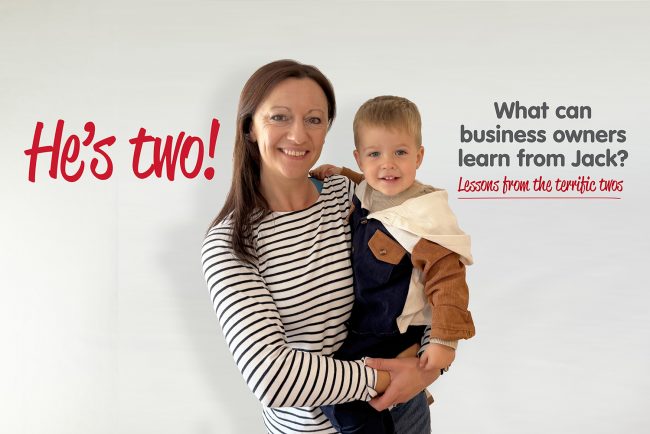 The-Terrific-Twos-Web Yvonne is holding her son. Yvonne is wearing a stripey blue and white long sleeved top and her son is wearing a brown and blue jacket. The words He's Two! are shown as well as What can business owners learn from Jack. Lesson from the terrific twos.